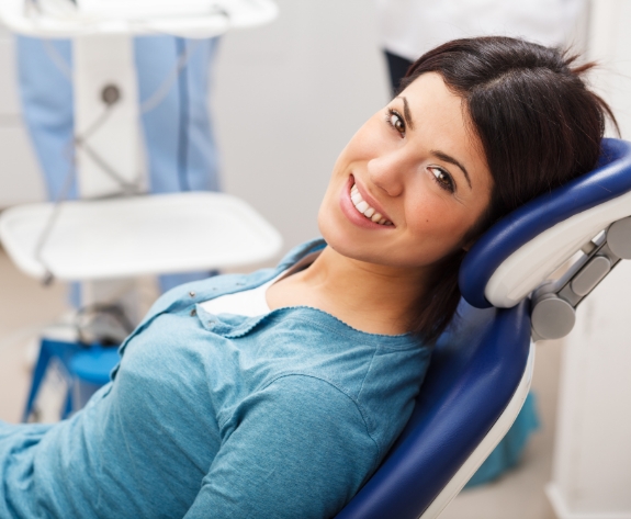 Smiling woman leaning back in dental chair in Danville dental office