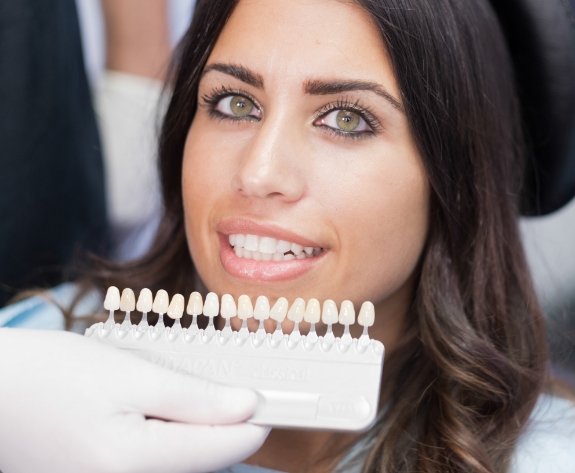 Woman trying on dental veneers from cosmetic dentist in Danville
