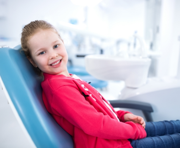 Young girl smiling while visiting emergency dentist in Danville