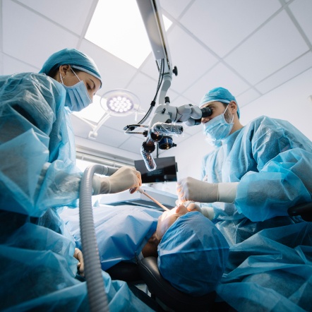 A team of dentists performing a dental implant surgery