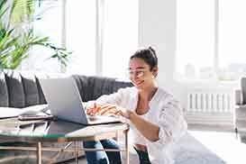 Woman smiling while working at home