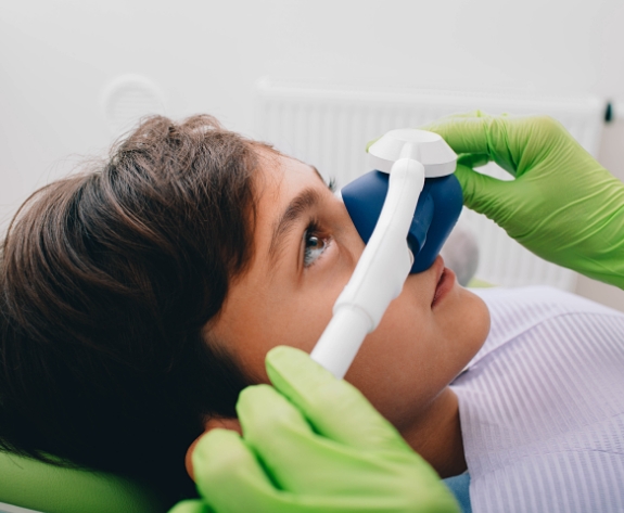 Young boy wearing nasal mask for nitrous oxide sedation dentistry