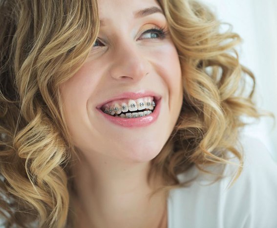 Teen with braces smiles