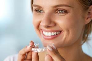 Young woman wearing an Invisalign aligner